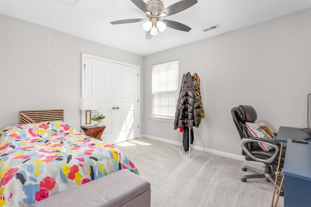 bedroom with ceiling fan, visible vents, attic access, carpet flooring, and baseboards