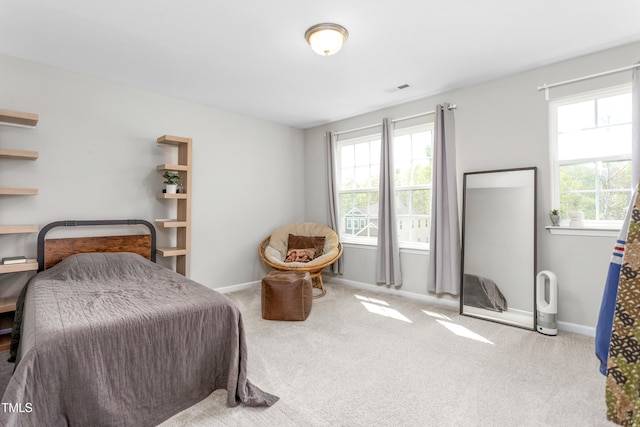 carpeted bedroom with baseboards and visible vents