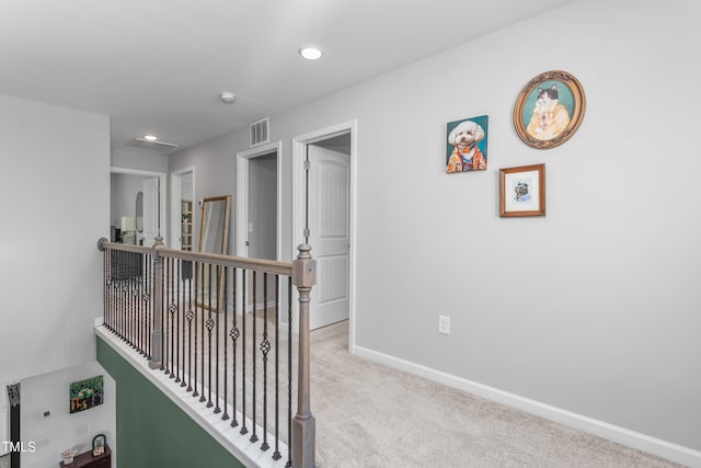 corridor featuring visible vents, recessed lighting, carpet flooring, an upstairs landing, and baseboards