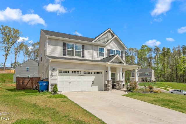 craftsman-style house featuring driveway, an attached garage, and a front lawn