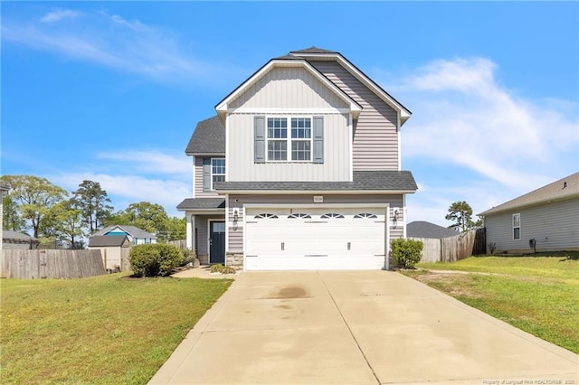 view of front of property with concrete driveway, board and batten siding, an attached garage, a front yard, and fence