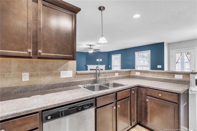 kitchen featuring dishwasher, a sink, pendant lighting, and a healthy amount of sunlight
