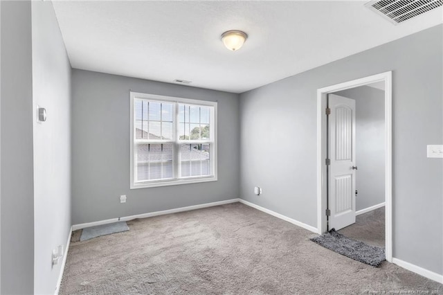 unfurnished room featuring carpet flooring, baseboards, and visible vents