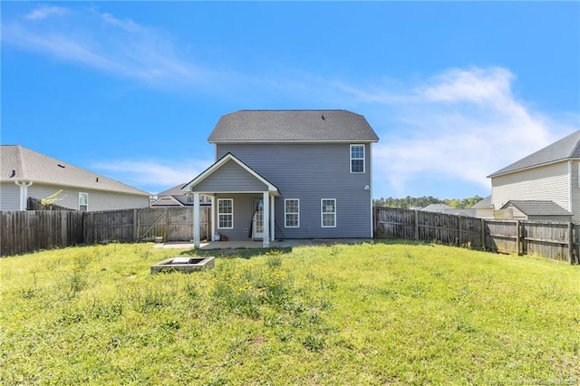 back of house with a yard, a patio area, and a fenced backyard