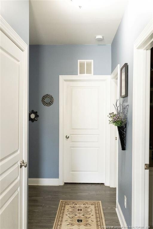 186 Kentucky Derby Ln, Lillington, NC 27546 - doorway with baseboards and dark wood-style floors