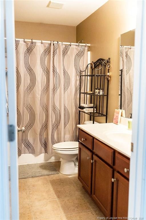 186 Kentucky Derby Ln, Lillington, NC 27546 - bathroom with toilet, vanity, and shower / bath combination with curtain
