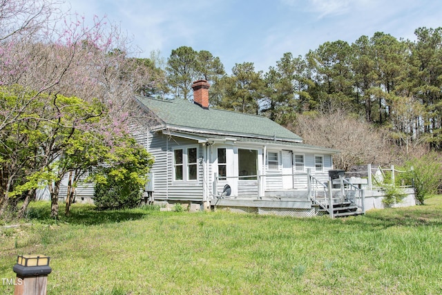 1556 Pleasants Rd, Wendell, NC 27591 - view of front of property featuring a front yard, a wooden deck, and a chimney