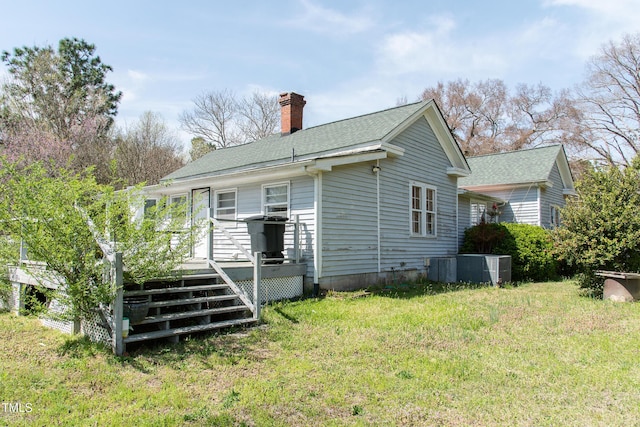 1556 Pleasants Rd, Wendell, NC 27591 - back of house featuring central air condition unit, a chimney, a wooden deck, and a yard