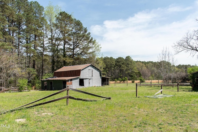 1556 Pleasants Rd, Wendell, NC 27591 - view of yard featuring an outbuilding, a forest view, fence, and a barn