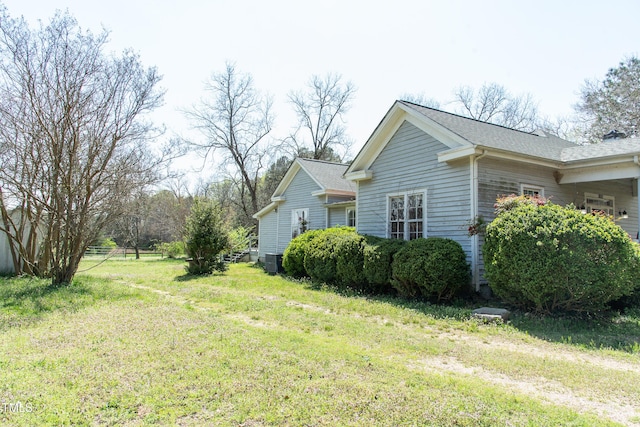 1556 Pleasants Rd, Wendell, NC 27591 - view of side of property with central AC, roof with shingles, and a lawn