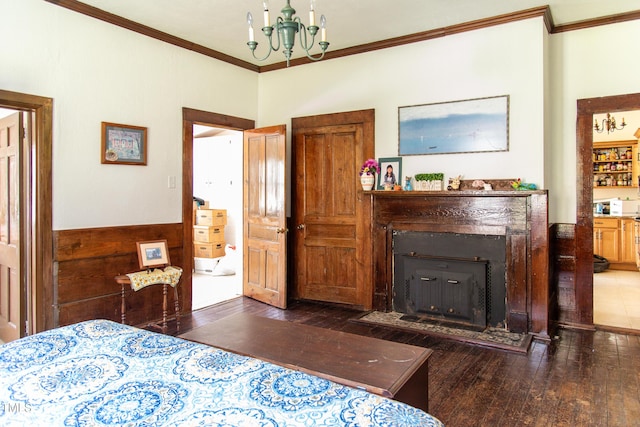 1556 Pleasants Rd, Wendell, NC 27591 - bedroom featuring ornamental molding, wood-type flooring, a notable chandelier, and a fireplace with flush hearth
