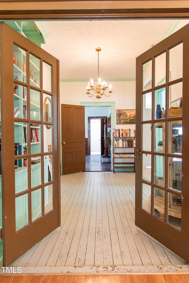 1556 Pleasants Rd, Wendell, NC 27591 - interior space featuring wood-type flooring, french doors, and an inviting chandelier