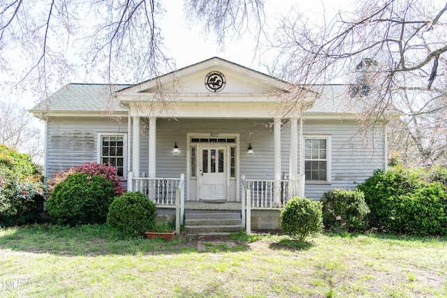 1556 Pleasants Rd, Wendell, NC 27591 - neoclassical home with a front yard, roof with shingles, a porch, and a chimney