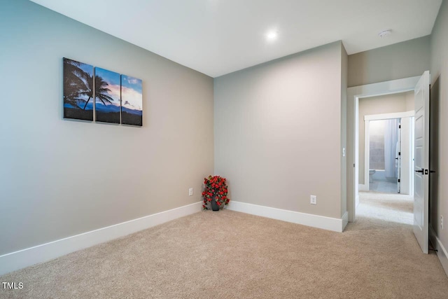 spare room with baseboards and carpet