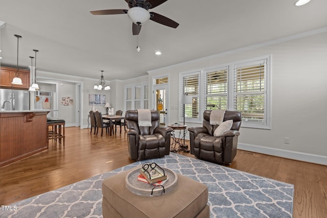 1512 Piazzo Ct, Apex, NC 27502 - living room with crown molding, baseboards, wood finished floors, recessed lighting, and a ceiling fan