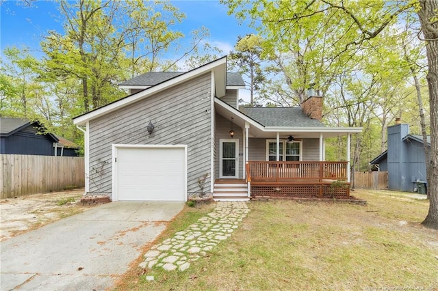 mid-century modern home with a chimney, driveway, a front lawn, fence, and covered porch