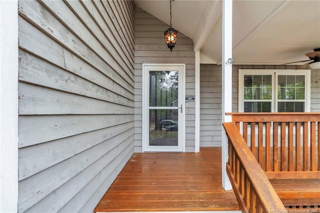 doorway to property featuring covered porch and ceiling fan