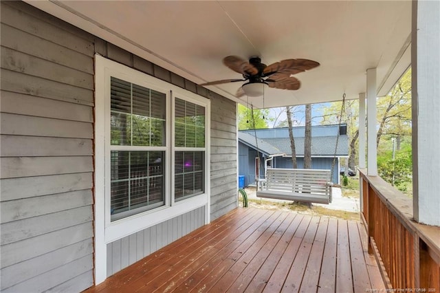 wooden terrace featuring a ceiling fan and covered porch