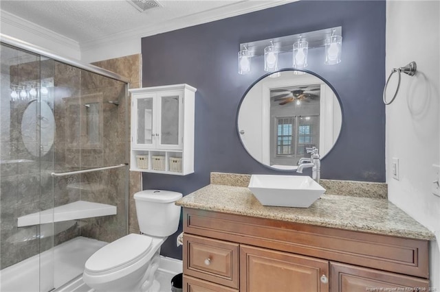 full bathroom featuring visible vents, toilet, crown molding, a shower stall, and vanity