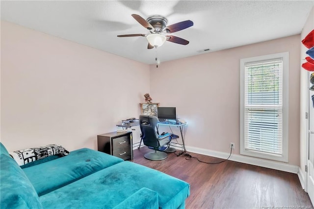 bedroom featuring wood finished floors, ceiling fan, baseboards, and visible vents