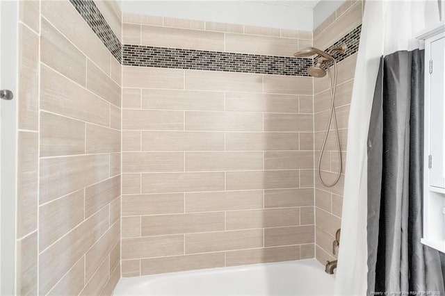 bathroom with shower / bath combination with curtain