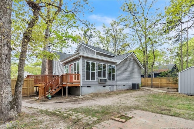 back of house featuring stairway, crawl space, central AC unit, a deck, and fence