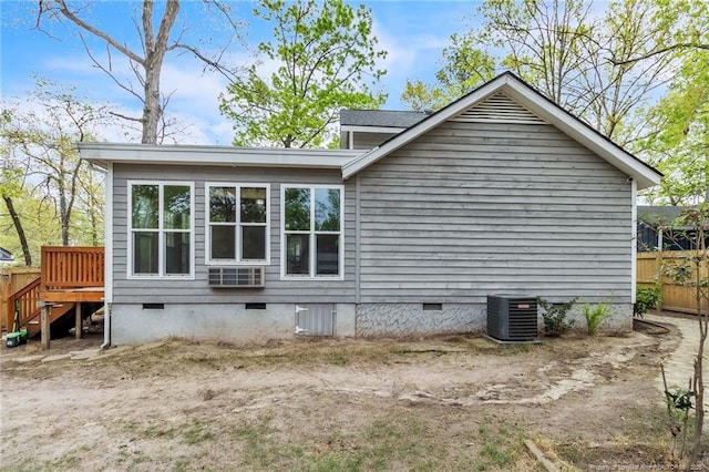 view of home's exterior featuring crawl space, central air condition unit, and fence