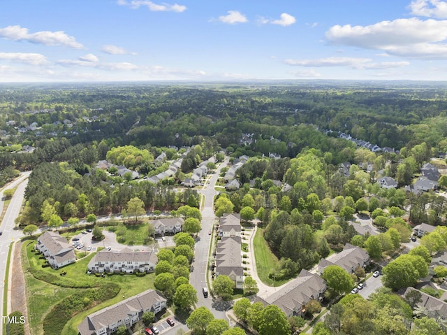 birds eye view of property with a wooded view and a residential view