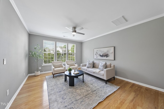 living room with light wood-style floors, ceiling fan, crown molding, and visible vents
