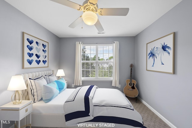 carpeted bedroom featuring visible vents, baseboards, and ceiling fan