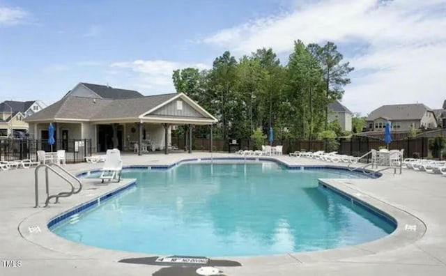 pool featuring fence and a patio