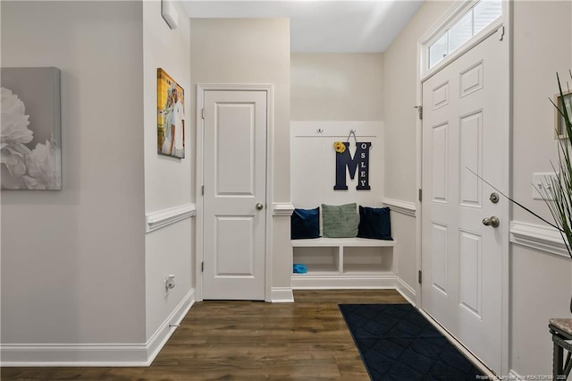 mudroom featuring dark wood-type flooring and baseboards