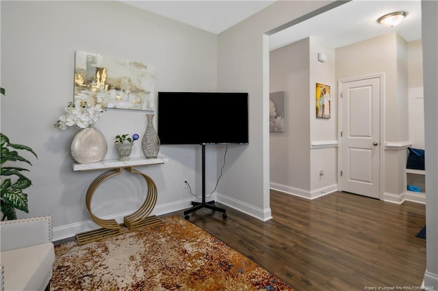 interior space with wood finished floors and baseboards