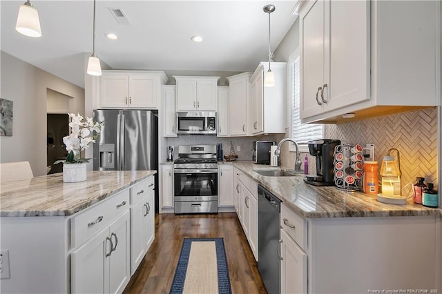 kitchen featuring visible vents, a sink, white cabinetry, stainless steel appliances, and dark wood-type flooring