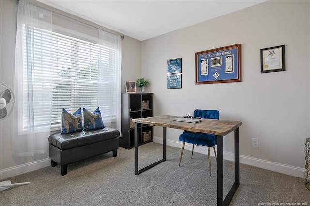 carpeted office space featuring baseboards