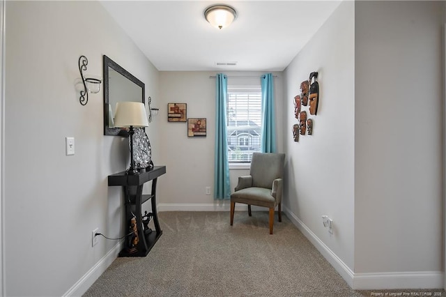 living area featuring carpet flooring, baseboards, and visible vents