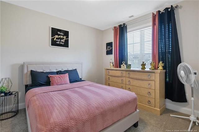 carpeted bedroom featuring visible vents and baseboards