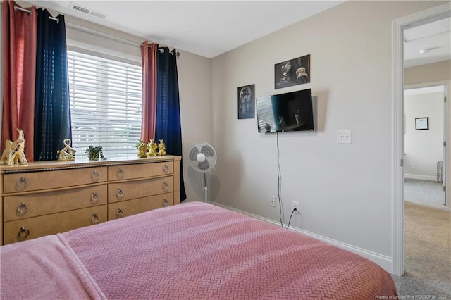 carpeted bedroom featuring visible vents and baseboards