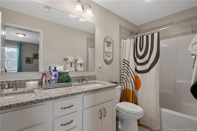 bathroom featuring a sink, shower / tub combo, toilet, and double vanity