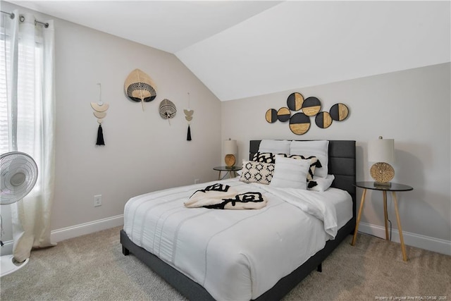 carpeted bedroom featuring baseboards and vaulted ceiling