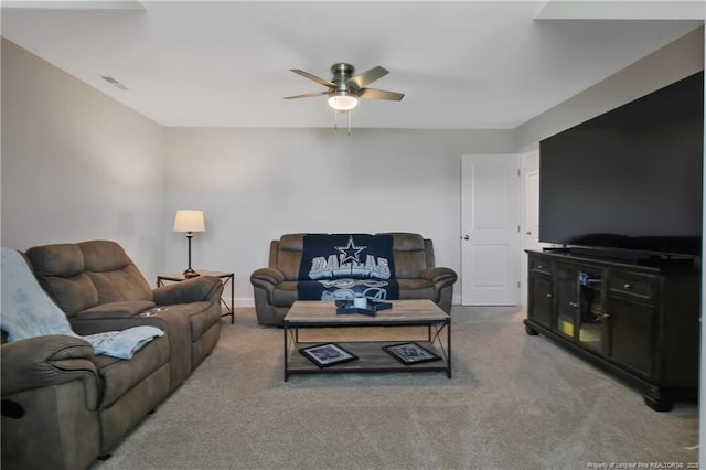 living room featuring visible vents, a ceiling fan, and light colored carpet