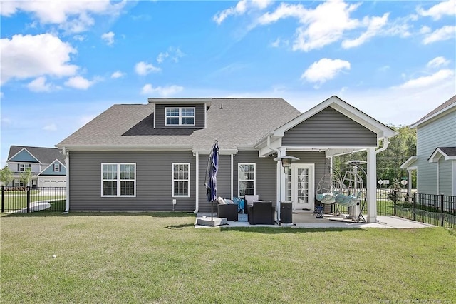 back of house with a patio, roof with shingles, a yard, and a fenced backyard