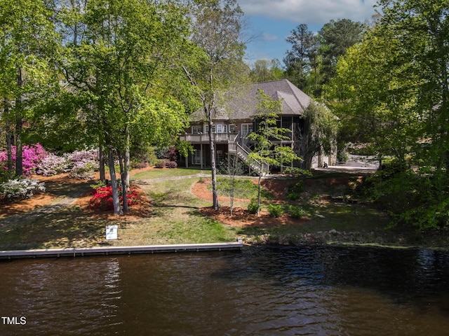 955 Sagamore Dr, Louisburg, NC 27549 - rear view of house featuring stairs and a deck with water view