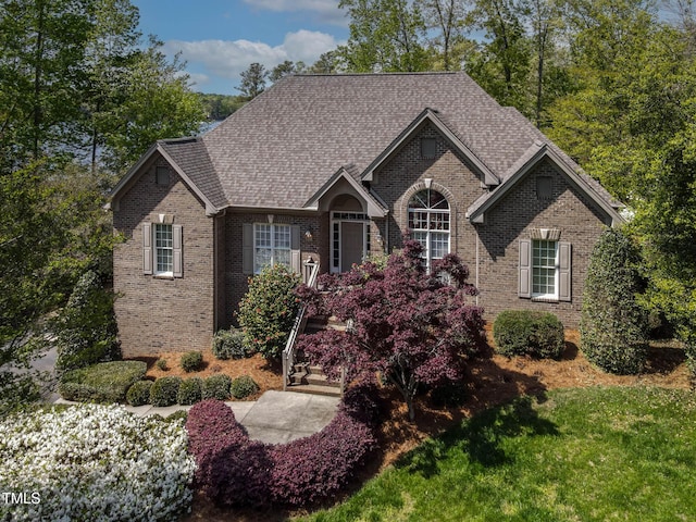 955 Sagamore Dr, Louisburg, NC 27549 - ranch-style house featuring roof with shingles, brick siding, and a front yard