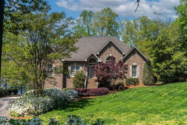 955 Sagamore Dr, Louisburg, NC 27549 - view of front of home with roof with shingles, a front lawn, and brick siding