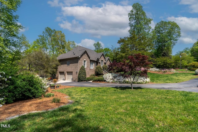 955 Sagamore Dr, Louisburg, NC 27549 - view of front of home featuring driveway, a garage, a front lawn, and brick siding