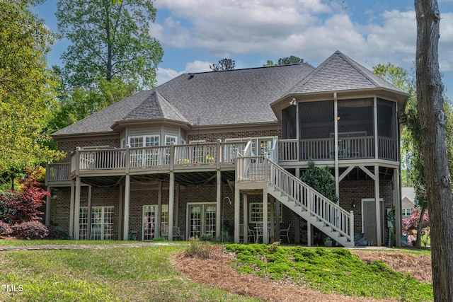 955 Sagamore Dr, Louisburg, NC 27549 - rear view of house featuring a sunroom, a lawn, stairs, brick siding, and a wooden deck
