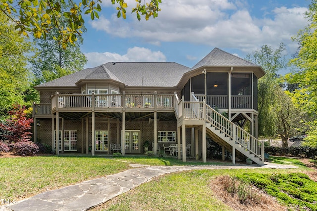 955 Sagamore Dr, Louisburg, NC 27549 - back of property with a sunroom, a yard, stairway, roof with shingles, and a deck