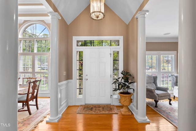 955 Sagamore Dr, Louisburg, NC 27549 - foyer entrance with light wood finished floors, ornate columns, a wainscoted wall, and a healthy amount of sunlight