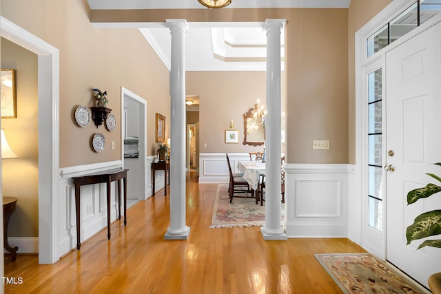 955 Sagamore Dr, Louisburg, NC 27549 - entryway featuring crown molding, a wainscoted wall, ornate columns, and light wood-style floors